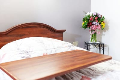 A cozy resident room with flowers and a bed