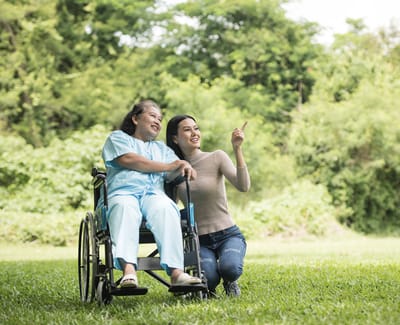 A resident in a wheelchair enjoying time outdoors