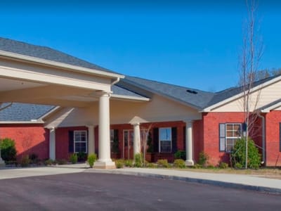 Exterior view of a senior living facility with covered entrance