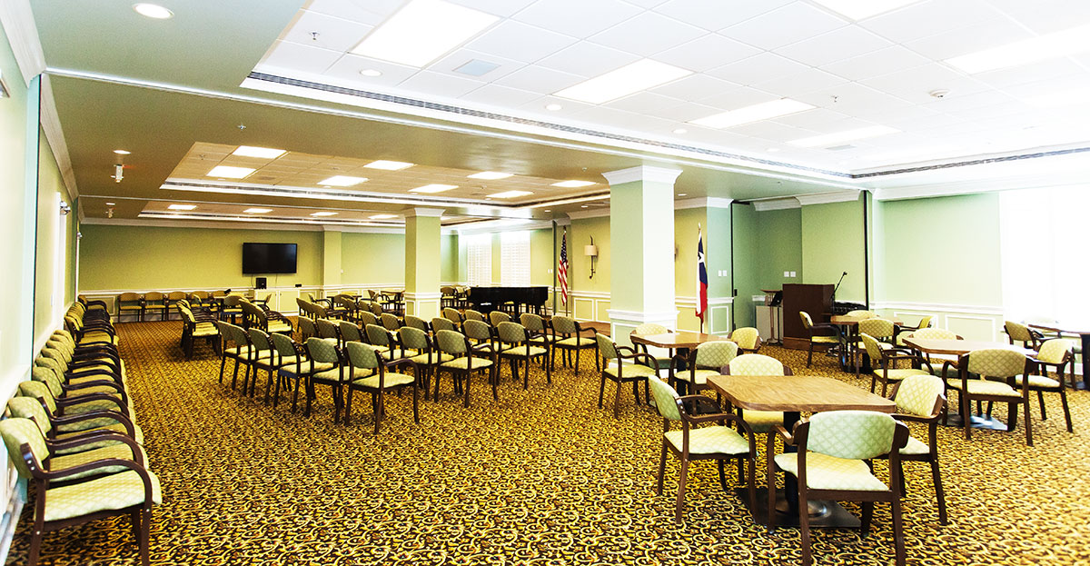 Bright common area with seating and piano