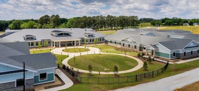 Aerial view of a senior living facility with green spaces