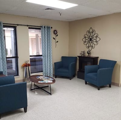 Comfortable common area with blue chairs and decor
