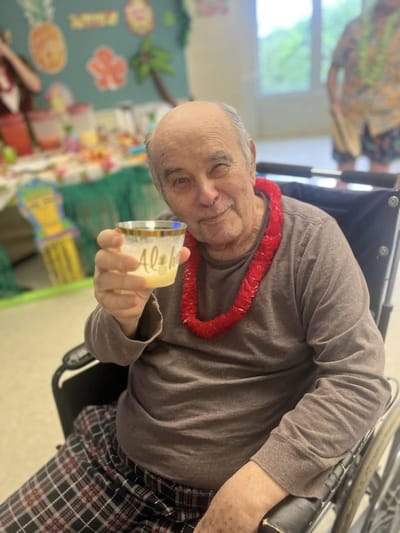 A resident enjoying a drink during a celebration