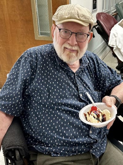 Senior man enjoying ice cream in a facility