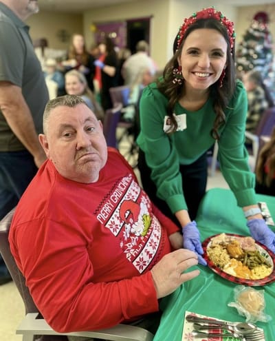 Resident enjoying a holiday meal with staff