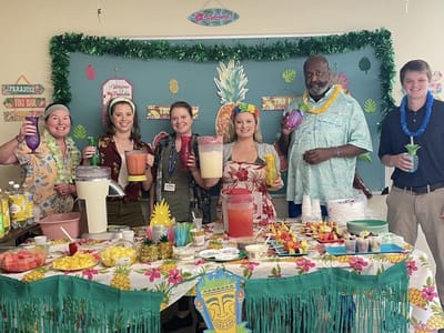 Staff and residents enjoying a tropical-themed party