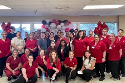 Staff members posing together in a celebratory event