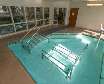 Indoor therapeutic pool with handrails