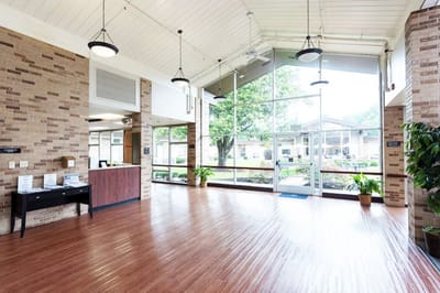 Bright lobby area with large windows and seating