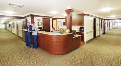 Staff members assisting residents at the reception area