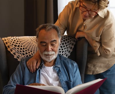 Senior couple enjoying time together with a book