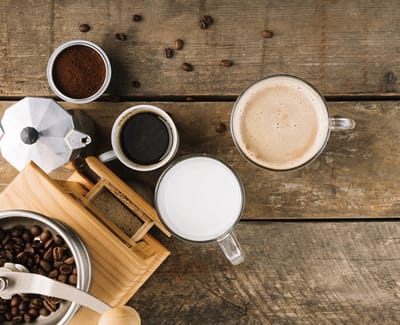 Coffee and milk preparations on a wooden table