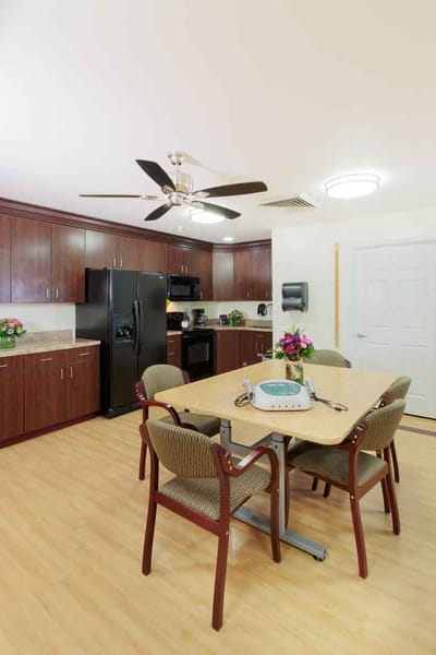 Bright common area with a dining table and kitchen appliances