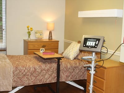 Cozy resident room with bed and lamp