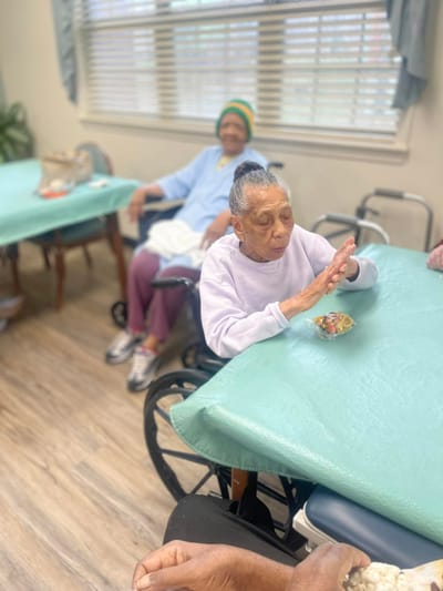 Residents in a common area enjoying a snack