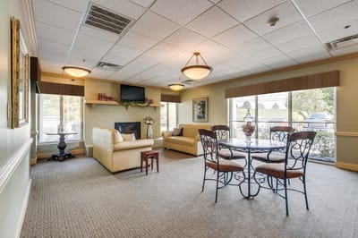 Bright interior common area with seating and a table