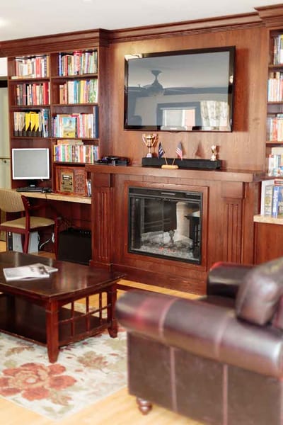 Cozy common area with bookshelves and a fireplace