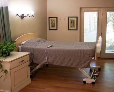 Private resident room with a hospital bed and bright lighting