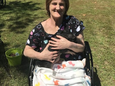 Resident enjoying time outdoors with a small dog