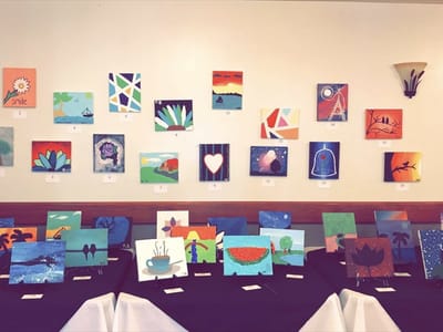 Art display from a resident art show on a wall