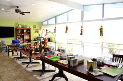 Activity space with tables and craft supplies for residents