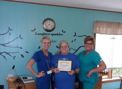 Staff and resident celebrating a milestone together