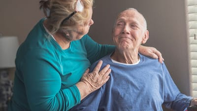 A woman interacting lovingly with a smiling man