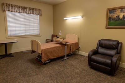 Simple private room with a bed and chair