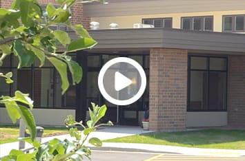 American Lutheran Home-Mondovi, Nursing Home in Mondovi, WI — Entrance of a senior living facility surrounded by greenery