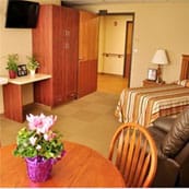 American Lutheran Home-Mondovi, Nursing Home in Mondovi, WI — Cozy senior living room with a bed and table