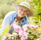 American Lutheran Home-Mondovi, Nursing Home in Mondovi, WI — Elderly woman gardening among blooming flowers