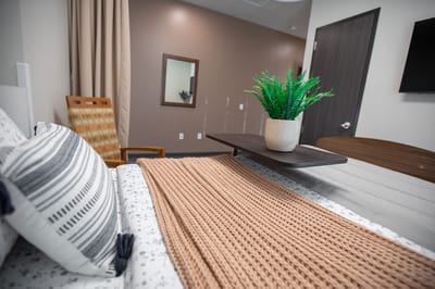 Cozy resident room with a plant and soft blanket