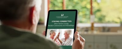 Resident interacting with a tablet in a common area