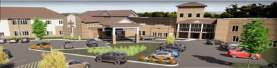 Exterior view of a senior living facility with parking area