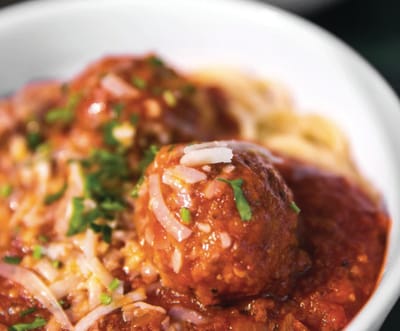 Close-up of a bowl of pasta with meatballs