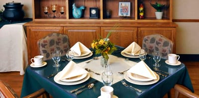 Dining table set for a meal in the communal dining area
