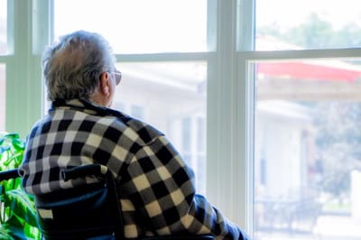Senior resident looking out the window
