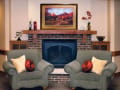 Alden Estates of Jefferson, Nursing Home in Jefferson, WI — Cozy lounge area with green chairs and fireplace