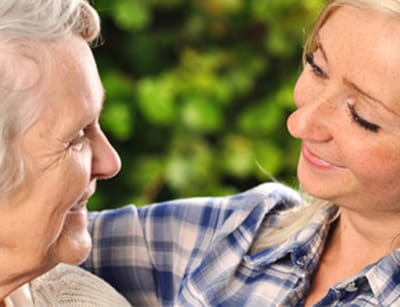 A caregiver interacting with a resident in a warm setting