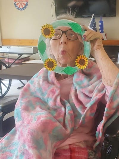 Resident playfully posing with a decorated frame