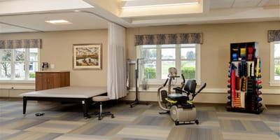 Interior view of a therapy room with exercise equipment