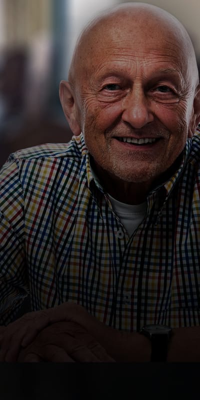 Smiling elderly man in a checkered shirt