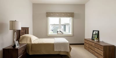 Private resident room with a bed and natural light