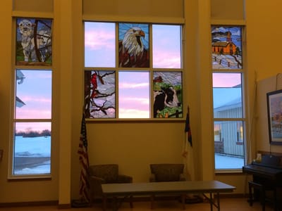 Interior of the facility with stained glass windows and seating