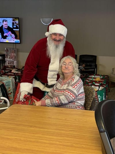 Santa Claus visiting a resident during a festive event