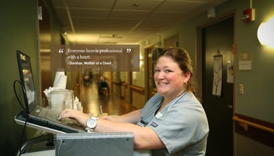 Staff member smiling at the reception desk