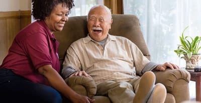 Meadowbrook Senior Living at Black River Falls, nursing home in Black River Falls, WI — Senior caregiver interacting joyfully with elderly resident