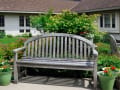 Alden Estates of Jefferson, Nursing Home in Jefferson, WI — Wooden bench surrounded by potted flowers and greenery