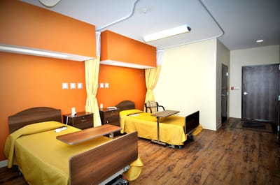 Two resident rooms with beds and bright decor