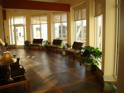 Bright interior hallway with seating and plants